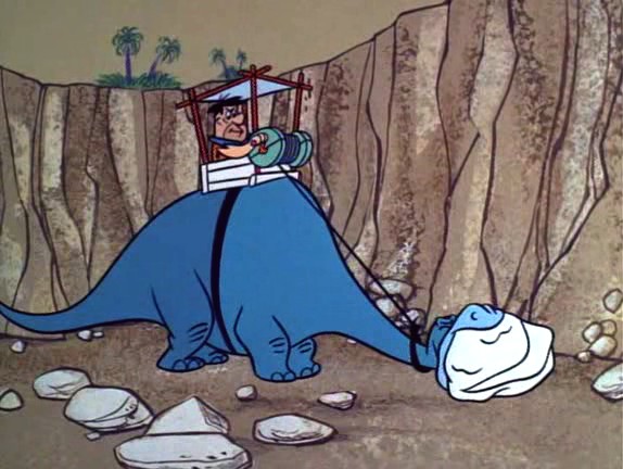 Fred Flintstone breaking rocks, to make rocks