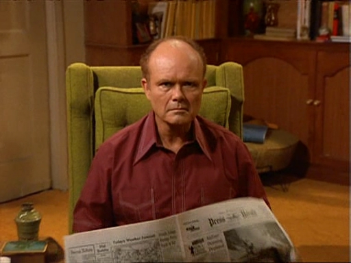 Red Forman reading a news paper