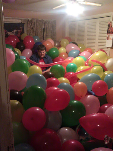 Walnut in a room full of balloons.